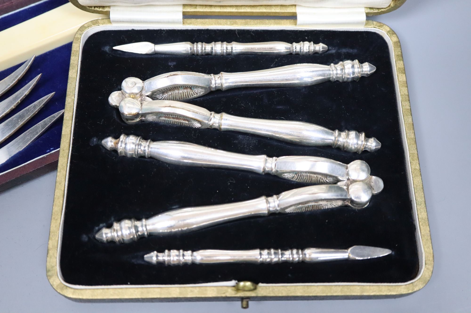 A pair of plated engraved bone handled fish servers, cased and a set of nut crackers, cased and assorted plated flatware.